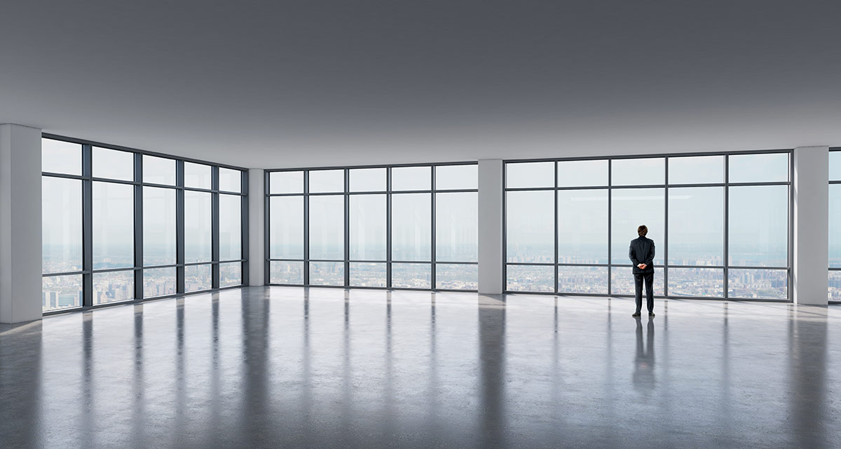 A man standing in a empty office space